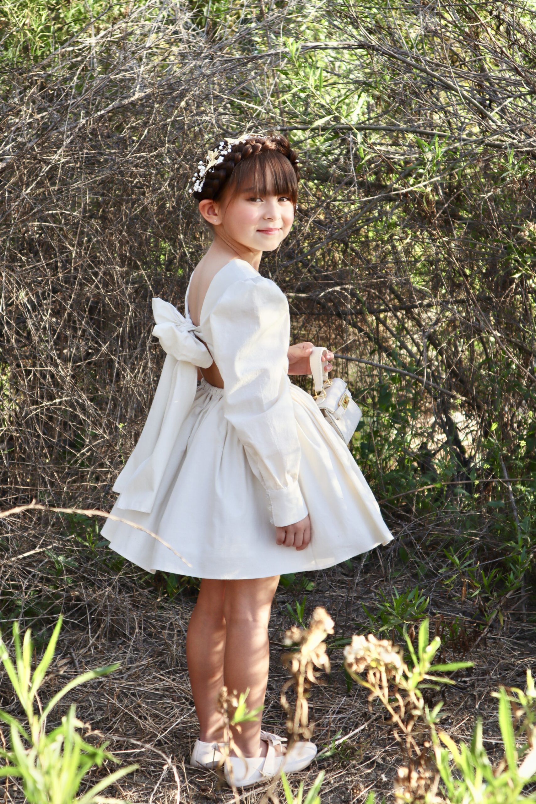 Girl in white dress standing in nature